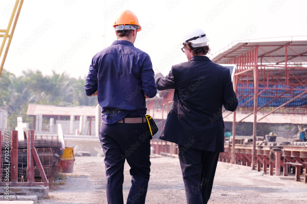 Engineers and workers inspecting work at construction site. Engineers and workers inspecting work at construction site.