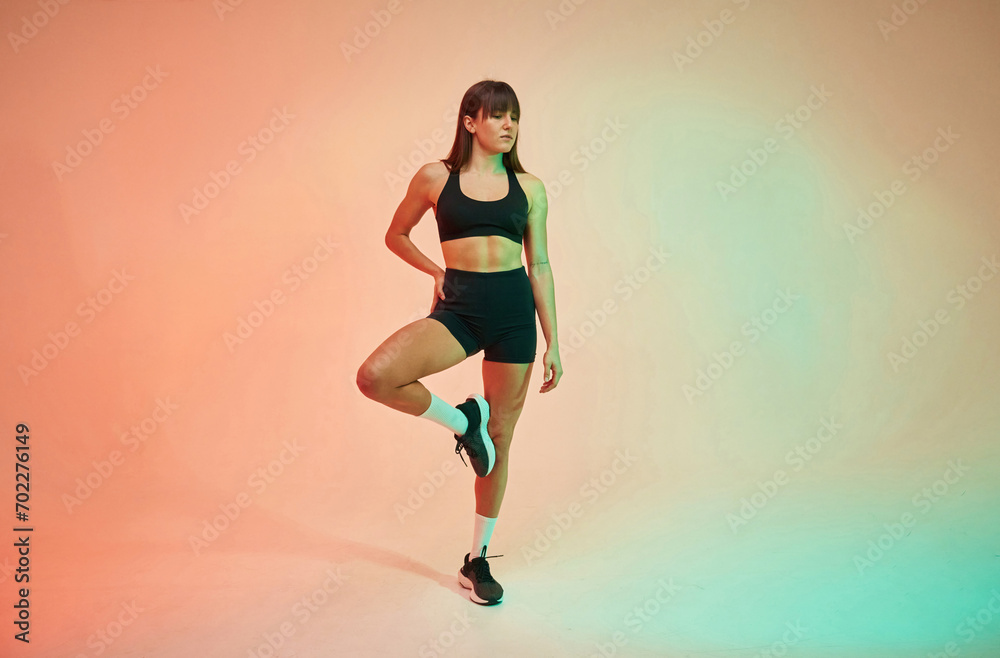 Young woman in fitness clothes is in the studio