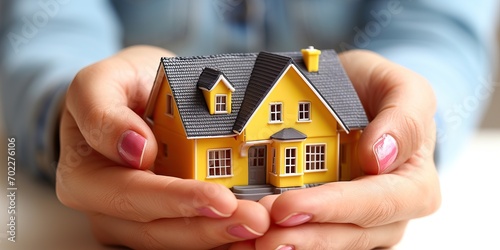 Hands holding a house sugge...