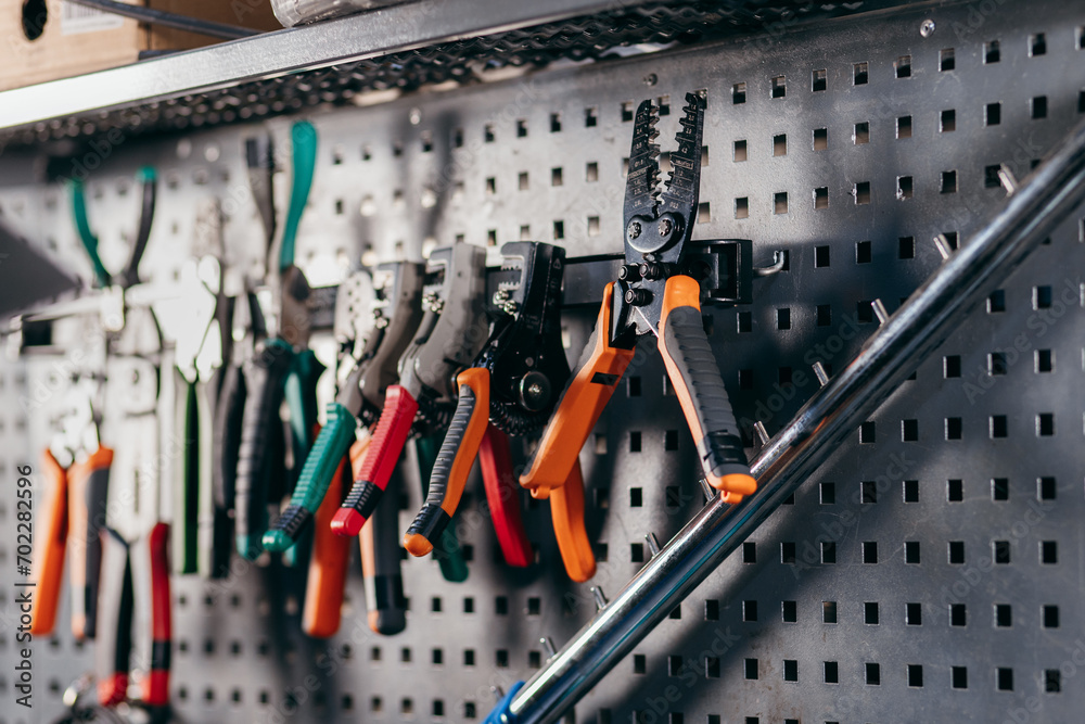 Fototapeta premium Tools for working with wires on a metal wall