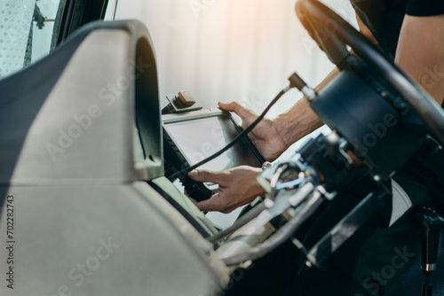 Young engineer installing autopilot system on tractor	
 photo