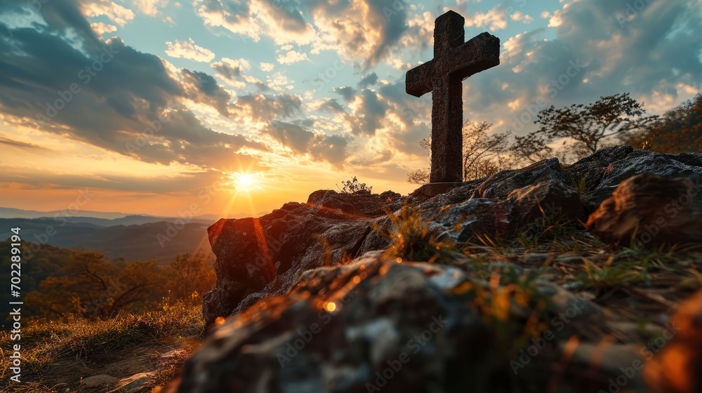 Christian cross on mountain top at Easter sunrise