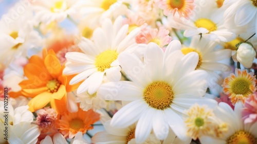 A bunch of white and orange flowers in a vase
