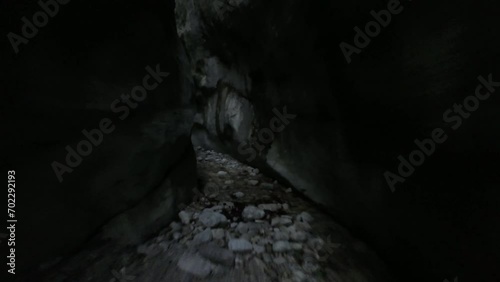 Wallpaper Mural aerial drone shot flying in a wild forest with a creek running down from ancient cave Torontodigital.ca