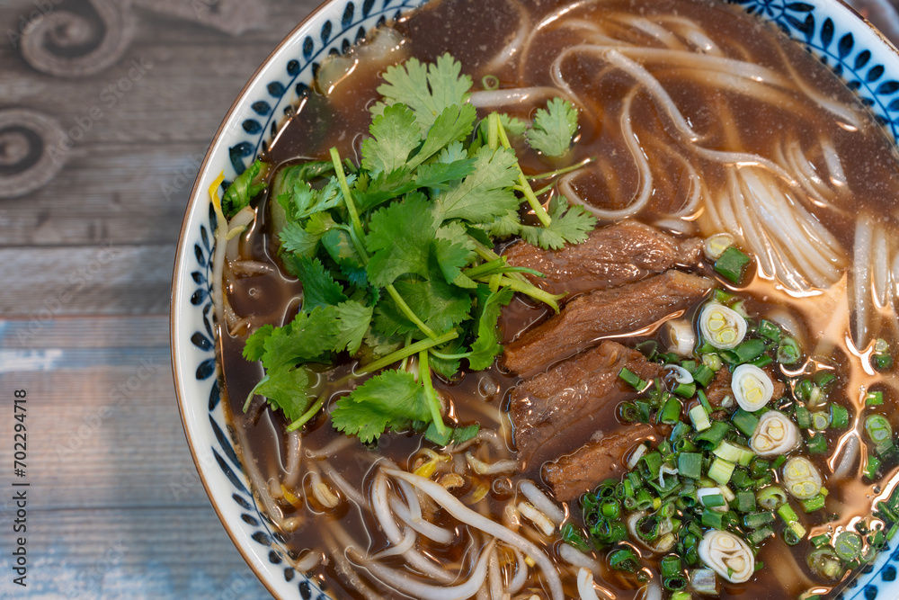 Closeup photo of beef rice noodle (pho), taken in a restaurant Closeup photo of beef rice noodle (pho), taken in a restaurant