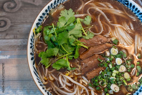Closeup photo of beef rice noodle (pho), taken in a restaurant