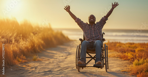 Happy African american black man on a wheelchair - diversity and inclusion concept - Praising the Lord - Praying for a miricale and healing - Happiness and independence despite disability photo