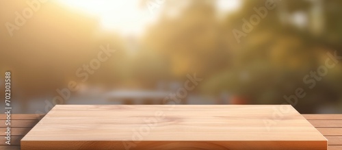Brown wood perspective for display of product, wooden board on table in front of blurred background.
