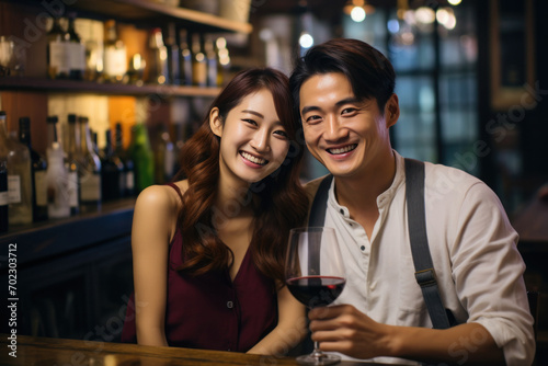 Cheerful Young Couple Enjoying Wine at a Cozy Bar 