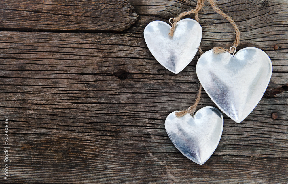 Obraz premium Metal hearts on wooden background