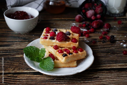 Hungarian waffles with berries on a wooden background. Breakfast. Dessert