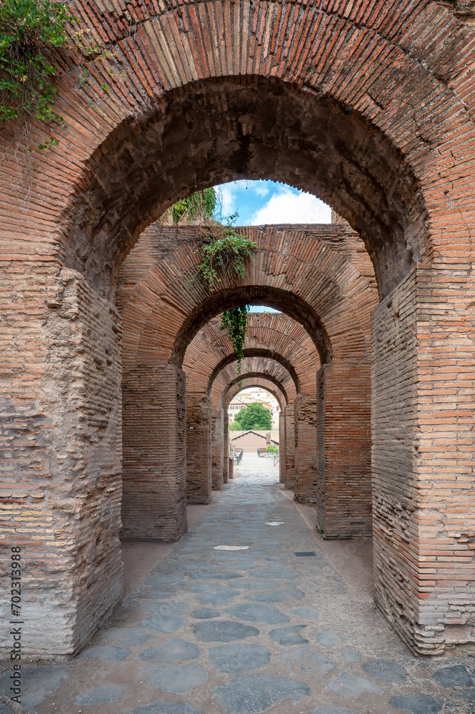 Close-up view of red brick Roman arches among the ruins of the famous Roman Forum (Foro Romano) in Rome, Italy