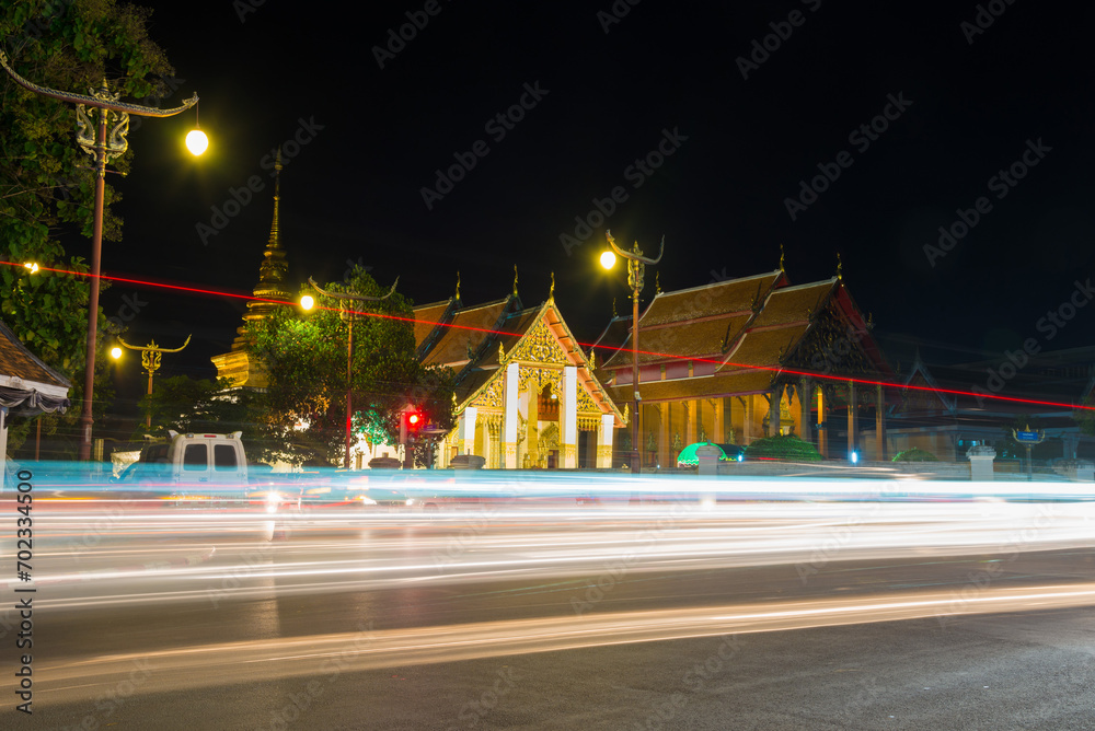 Wat Phrathat Chang Kham Worawihan in twilight scene with light trails from long exposure.