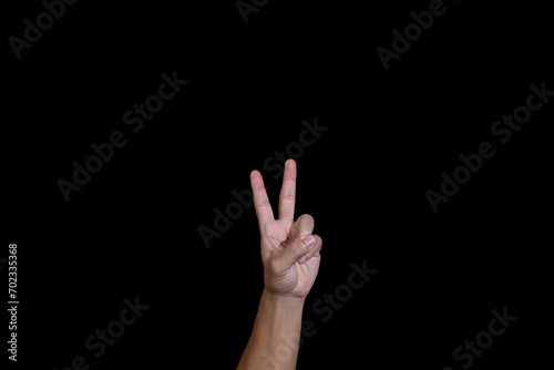 A hand isolated on black background. American sign language alphabet V.