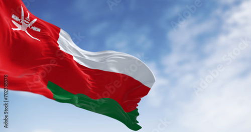 National flag of Oman waving in the wind on a clear day photo