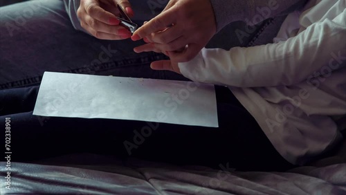 Unrecognizable person, mother, nanny,woman cuts nails of little girl, daughter, granddaughter at home with nail scissors. Timelapse. Motherhood. Love and care. Health and hygiene. 4k footage.