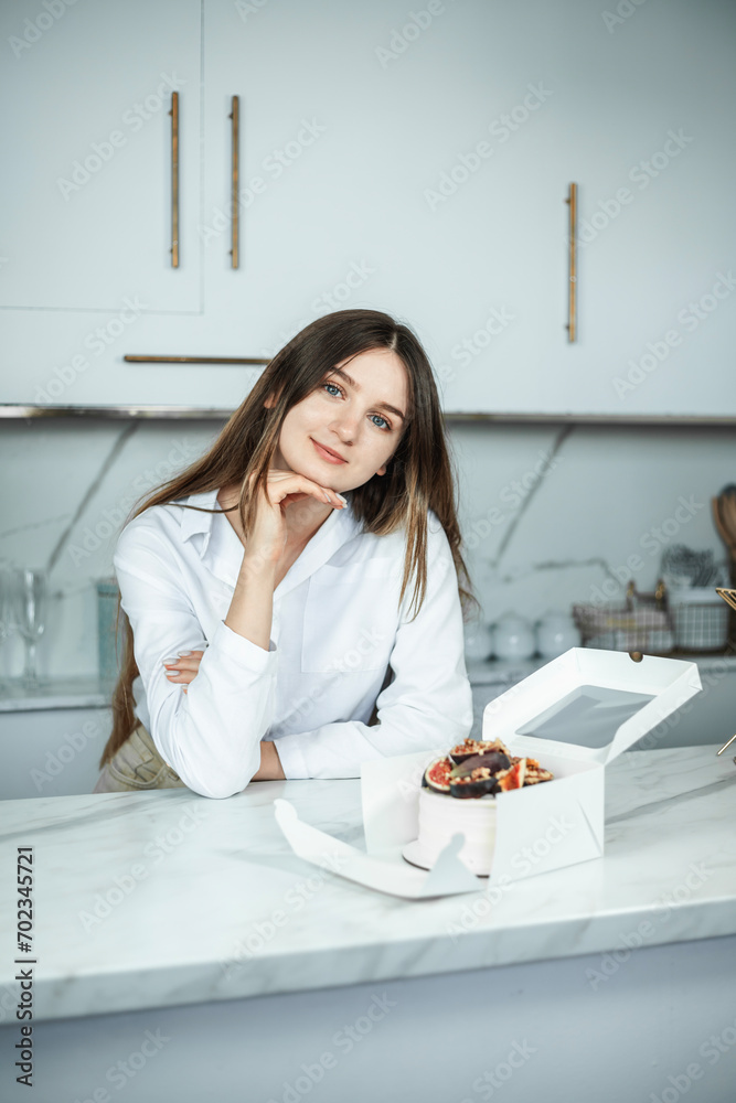 Portrait of confectioner woman with cake made by her hands Portrait of confectioner woman with cake made by her hands