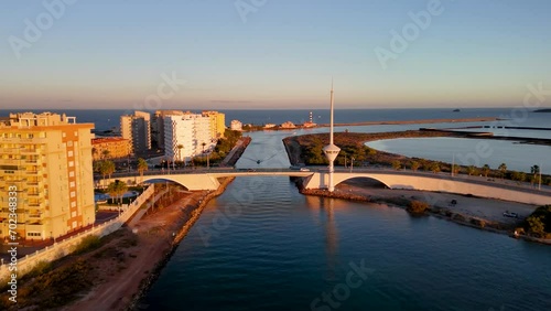 Wallpaper Mural Drone aerial view of a boat passing under the canal bridge that divides the Mar Menor and the Mediterranean Sea in La Manga, Murcia, Spain. Torontodigital.ca