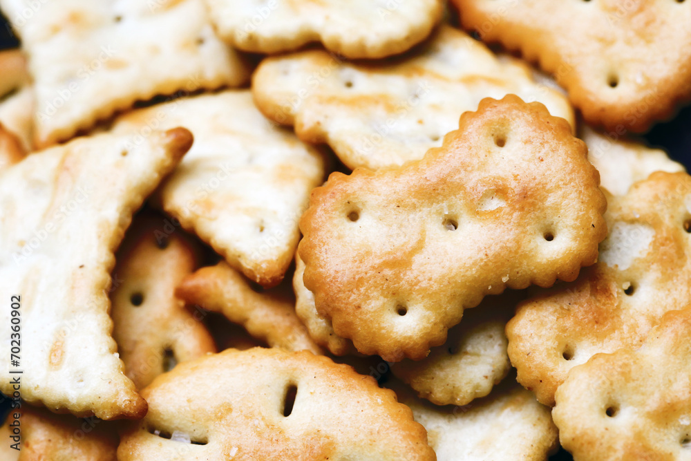Saltine crackers on a plate. Crunchy party snack. Various shapes crackers background. Party food closeup texture. Baked crisps background. Saltine crackers on a plate. Crunchy party snack. Various shapes crackers background. Party food closeup texture. Baked crisps background.
