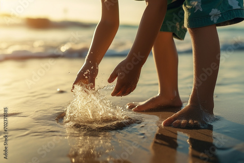 Child rinsing sand off feet at beach in summer