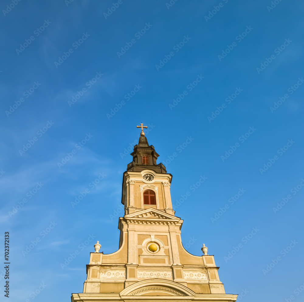 Christian church tower on a clear blue sky with copy space, minimalist composition 