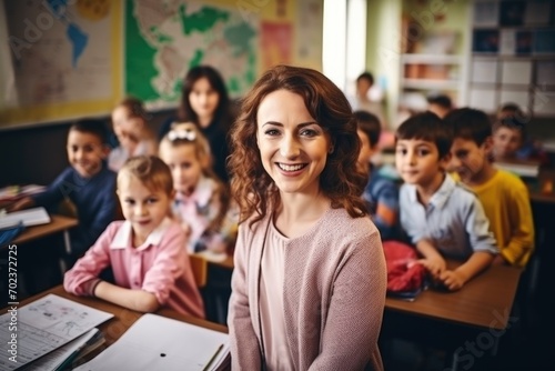 Elementary school teacher standing in front of the class with students in the background