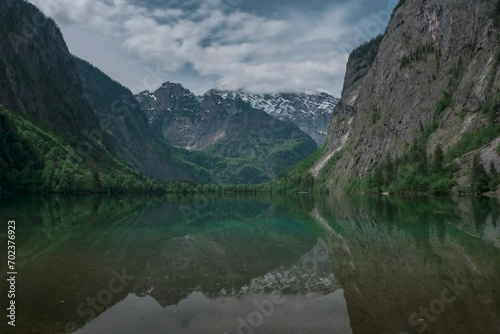 Timelapse of reflections of Watzmann mountain cliffs on lake Obersee at Berchtesgaden Bavaria, moving clouds in sky and turquoise water, Berchtesgaden Bavaria.