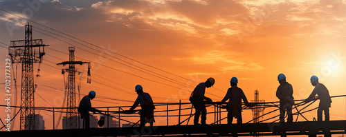 silhouette workers on construction site in evening sunny backround.