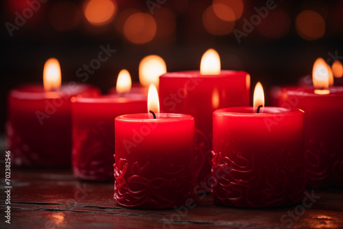 candles red with flickering flames  dark blurred background  selective focus