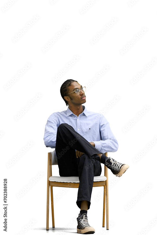 Obraz premium A man in a gray shirt, on a white background, is sitting on a chair