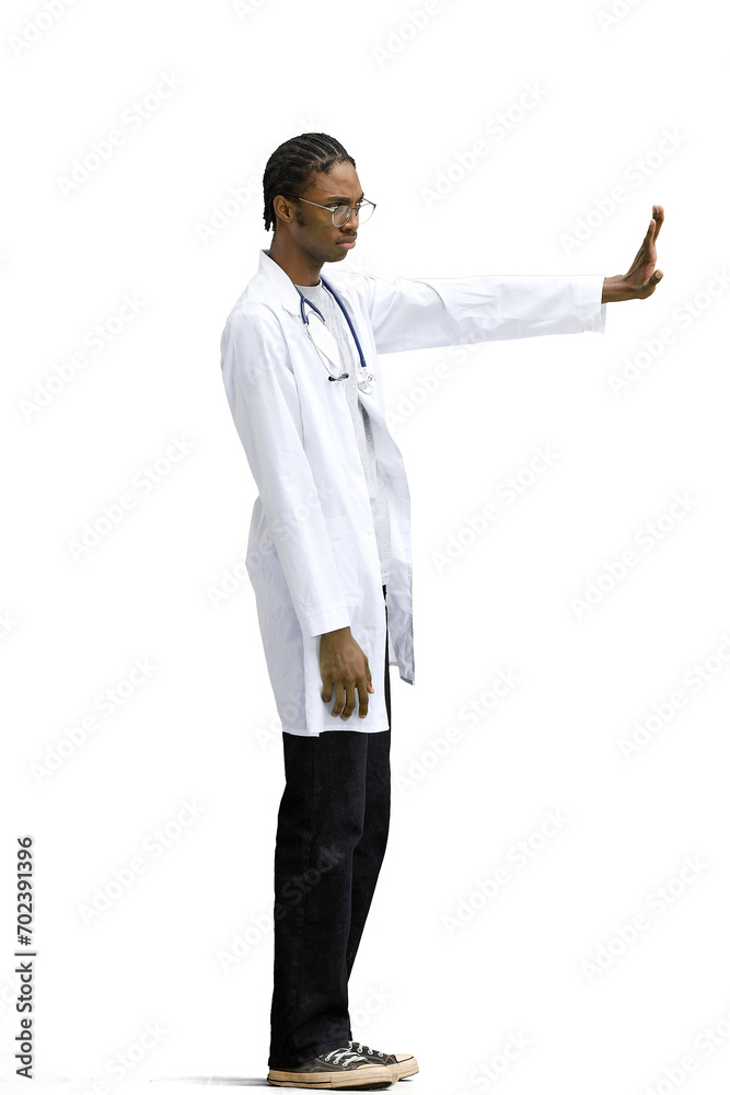 A male doctor, on a white background, in full height, shows a stop sign A male doctor, on a white background, in full height, shows a stop sign