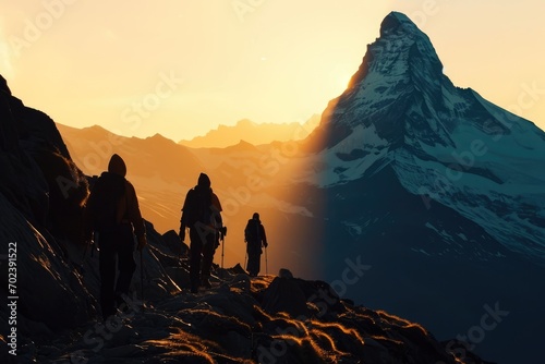 Majestic Matterhorn Sunrise: Embark on a sunrise trek to the Matterhorn, witnessing a panoramic view of surrounding mountains, with silhouetted trekkers walking in the serene alpine landscape.   © Mr. Bolota