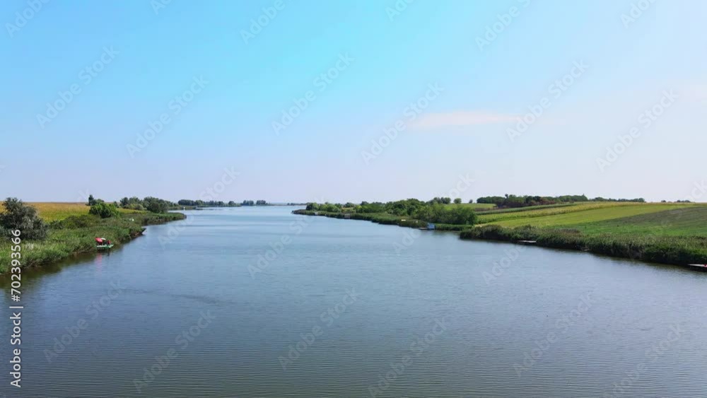 Drone glides above lake surface in bright summer day Drone glides above lake surface in bright summer day