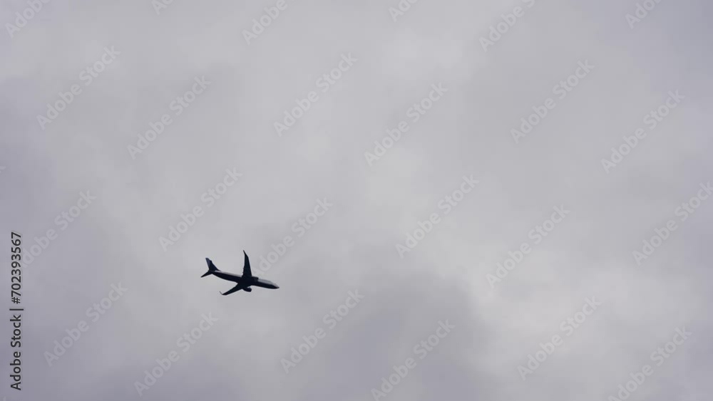 Passenger plane fly through clouds landing on approach to international airport, cinematic slow motion shot Passenger plane fly through clouds landing on approach to international airport, cinematic slow motion shot