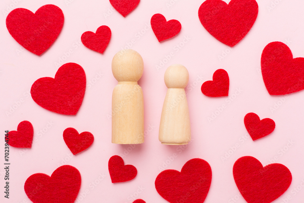 Wooden couple in love on color background, top view. Creative valentine's day composition Wooden couple in love on color background, top view. Creative valentine's day composition