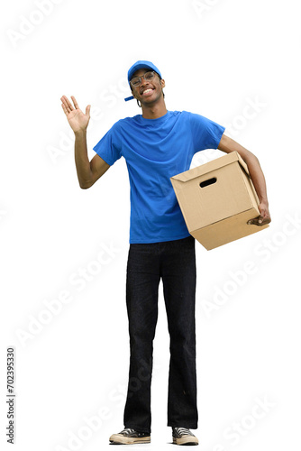 A male deliveryman, on a white background, full-length, with a box, waving his hand © Katsiaryna
