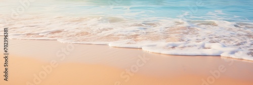 A close-up shot of gentle waves caressing the shore on a pristine sandy beach