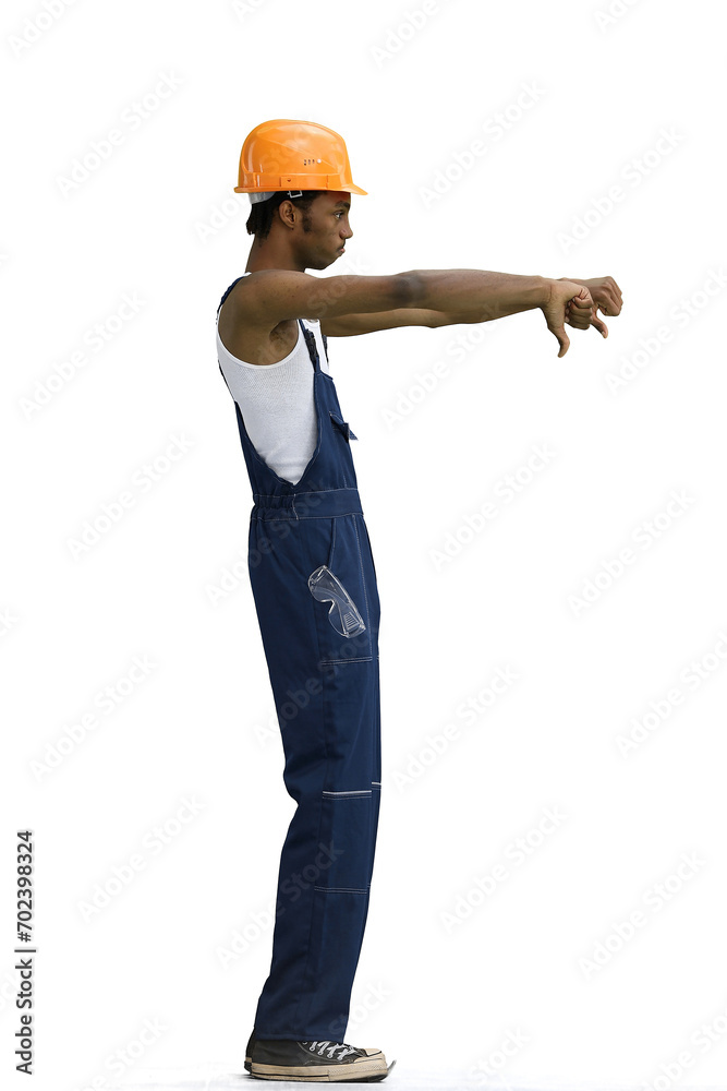 A male construction worker, on a white background, in full height, shows his thumbs down A male construction worker, on a white background, in full height, shows his thumbs down