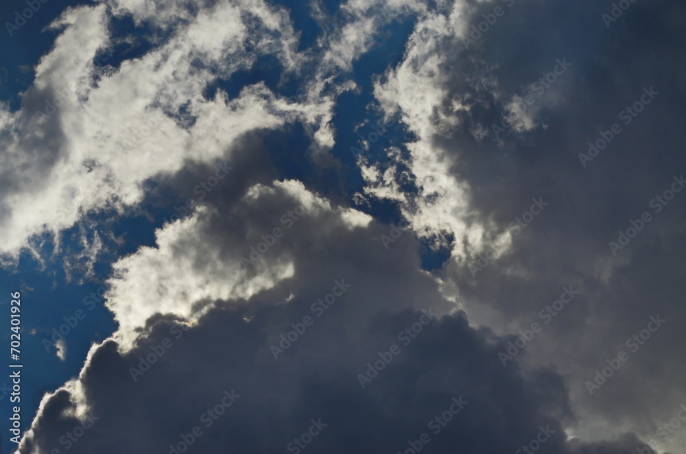Background of rainy fluffy clouds floating on a bright blue sky, Sofia, Bulgaria   
