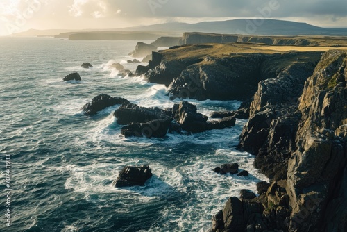 Majestic clouds roll over the rugged headland as the relentless tide crashes against the towering cliffs  creating a dramatic seascape that embodies the wild beauty of nature