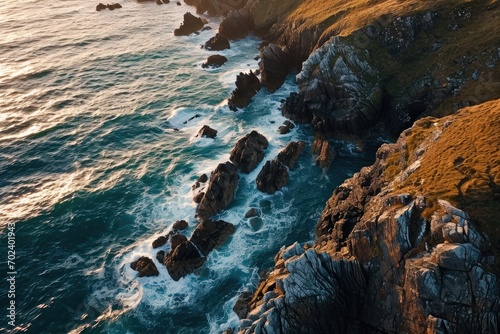 Nature's force on full display as wind waves crash against the rugged cliffs of a coastal headland, painting a breathtaking seascape of mountains and sea