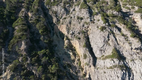flying along a rocky mountain range in Arrabida Natural Park, Setubal, Portugal photo