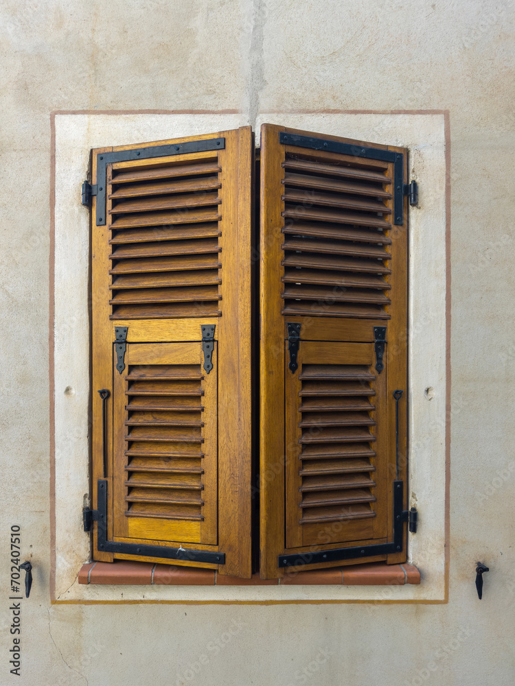 Wooden window with closed shutters on grey wall, Corte, Haute-Corse, Corsica, France.
