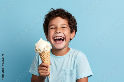 Smiling Boy Holding Vanilla Ice Cream Cone blue background