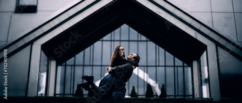 couple in love hugs against the backdrop of a new frame house, happiness from buying a home in the family