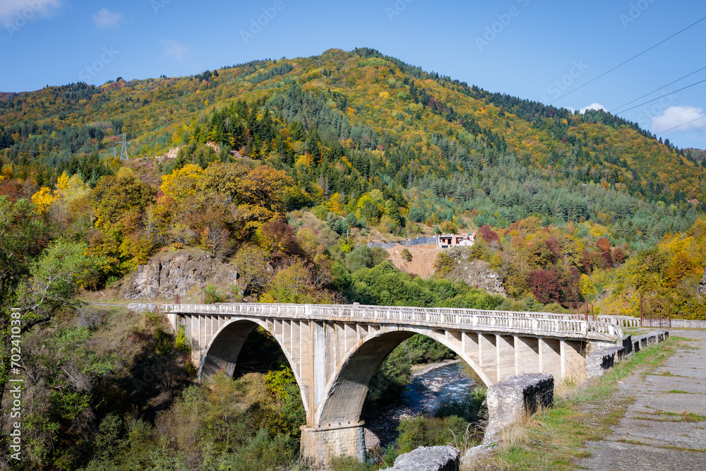 Elevated Bridge Over a River Amidst the Majestic Mountain Landscape