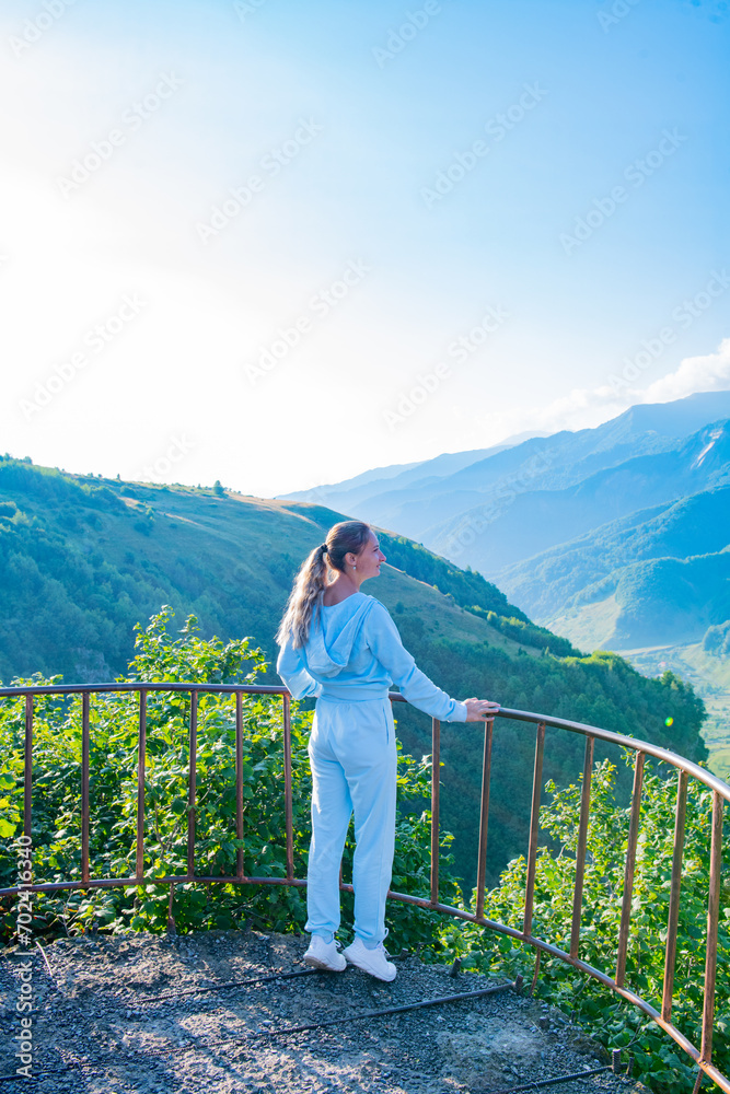 Young Adventurer in Blue Suit Standing on Mountain Observation Deck