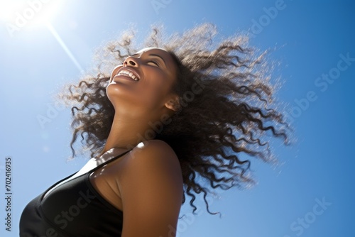 Stock photography of a black African American woman. Mind. Launching, blue sky background photo