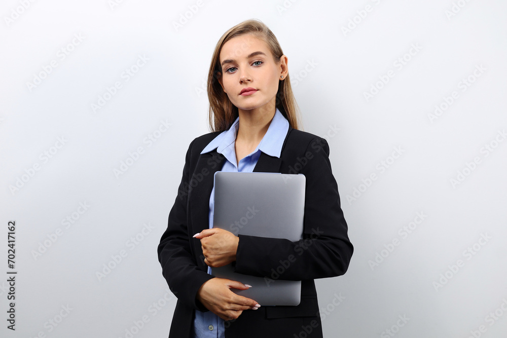 Portrait of a successful business woman with a laptop on a light background with copy space Portrait of a successful business woman with a laptop on a light background with copy space