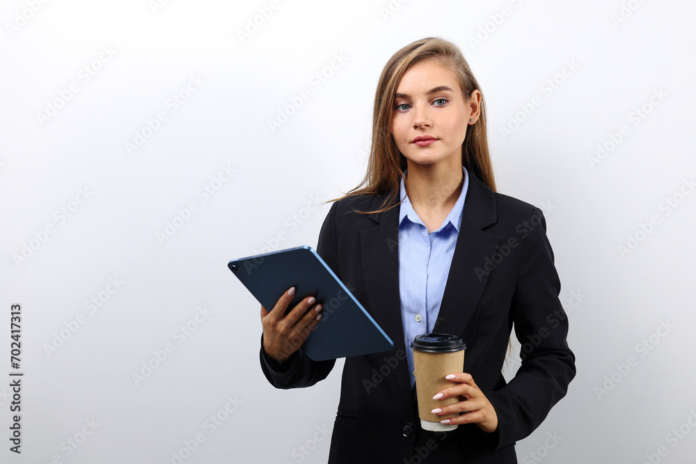 Cute female secretary using tablet for work purposes Cute female secretary using tablet for work purposes